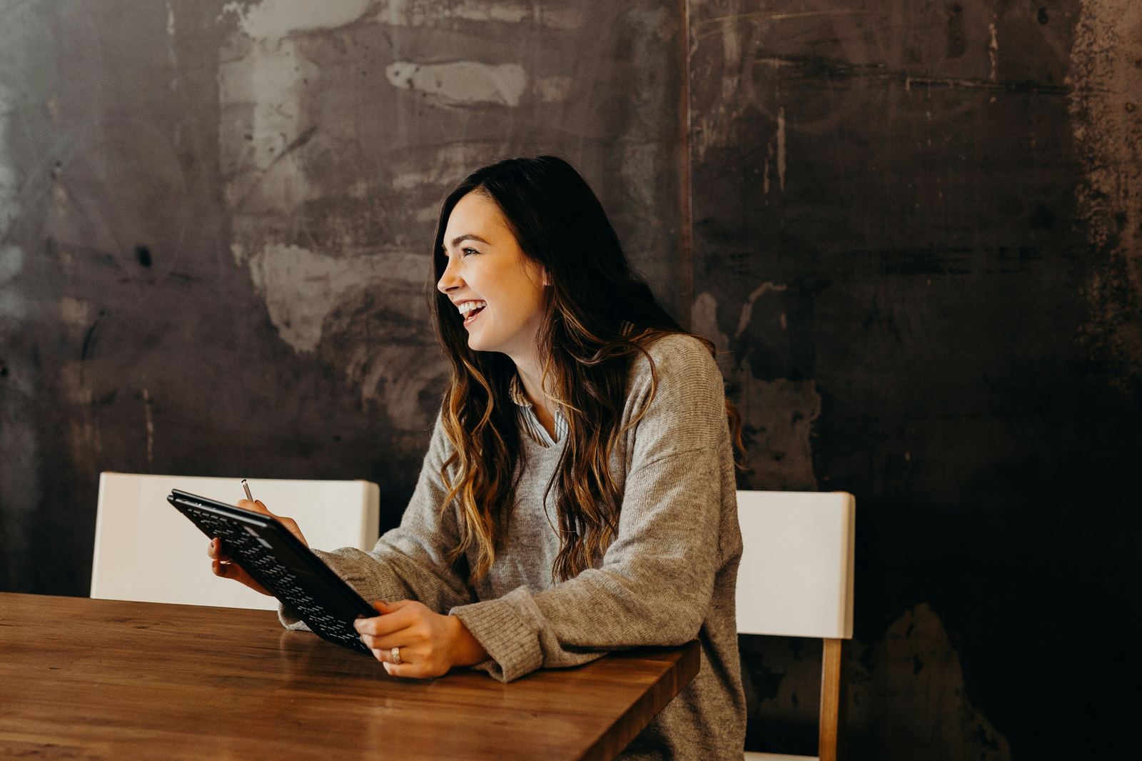 Smiling small business owner working on laptop